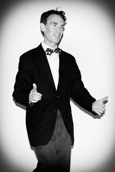 Bill Nye magically appears and walks up to the podium.